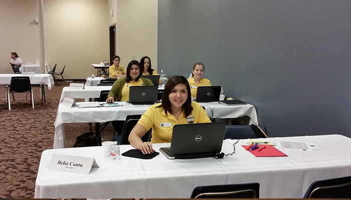 AB 3 MHP Salud CHWs using laptops.
