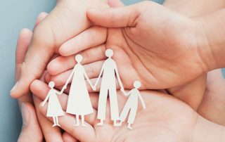 Hands Holding Cutout Shapes of Family